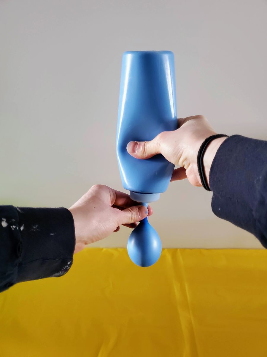 Filling a Balloon with Blue Paint Using a Reusable Condiment Bottle