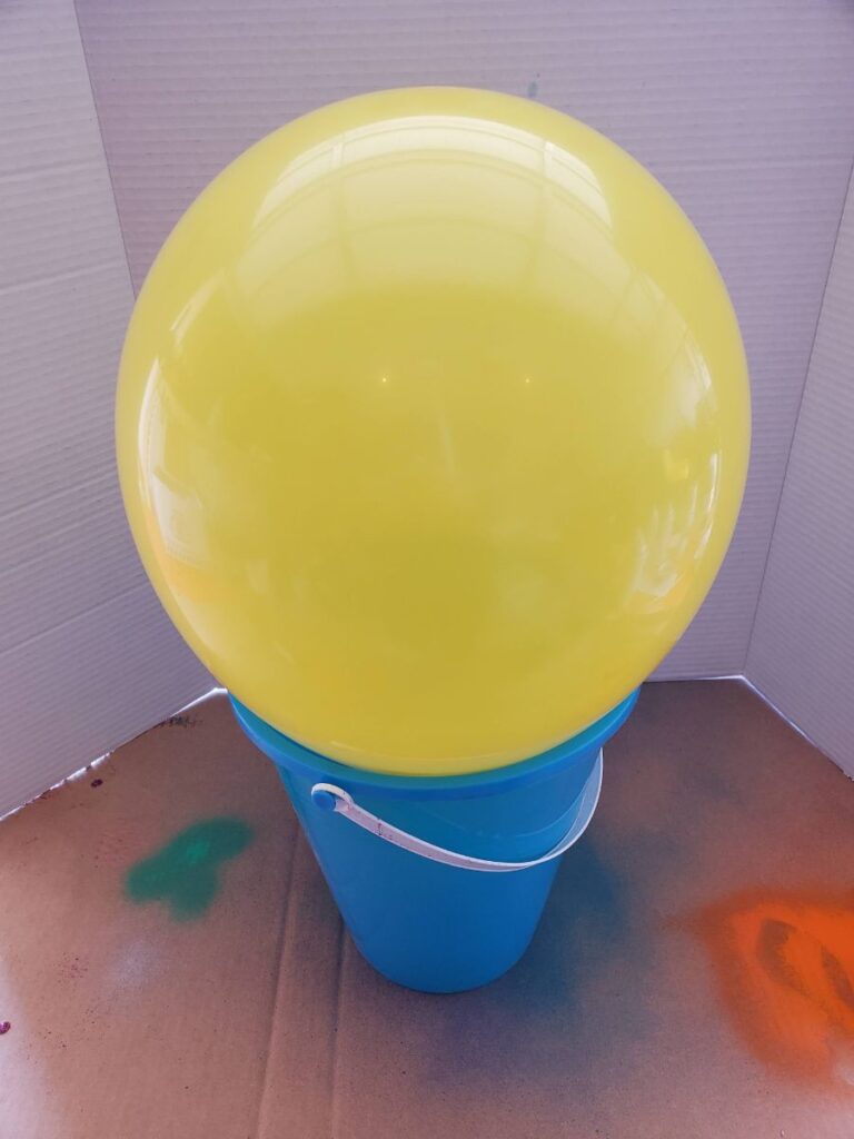Using a Bucket to Hold Balloon to Be Painted